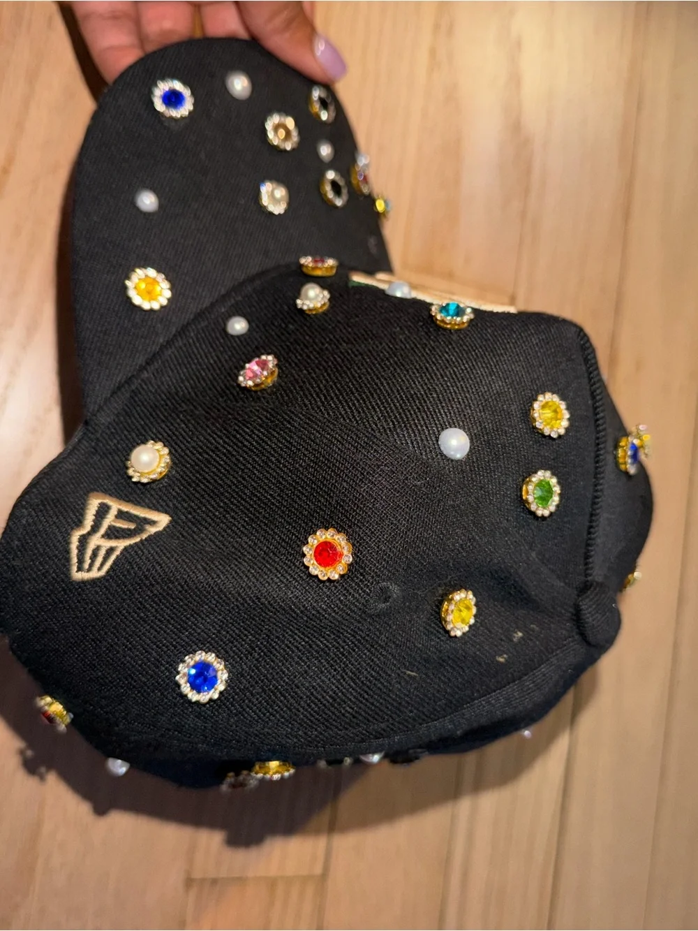 Embellished Black Baseball Cap with Gold Embroidered Rose Accent